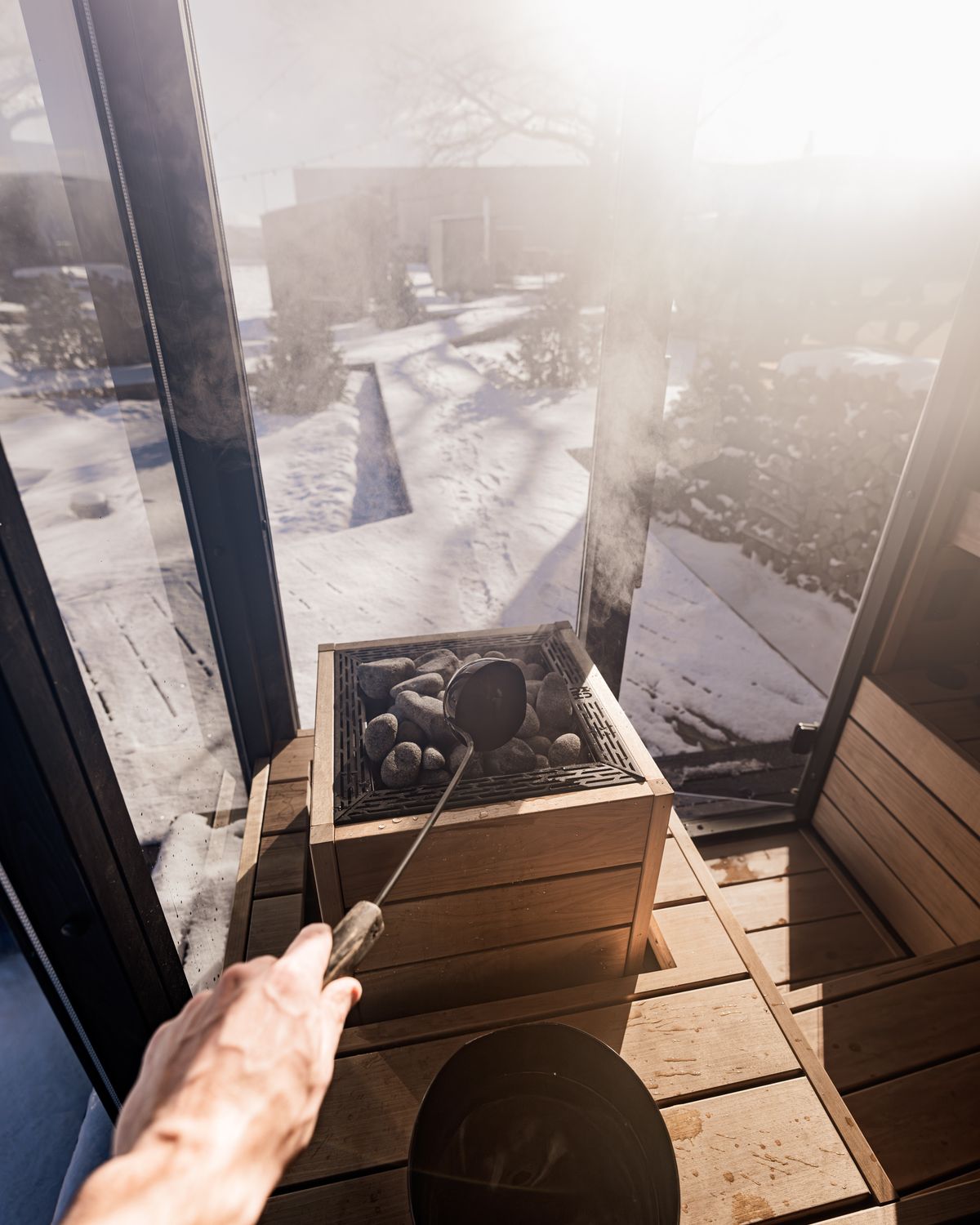 The larch sauna with a window on the snow