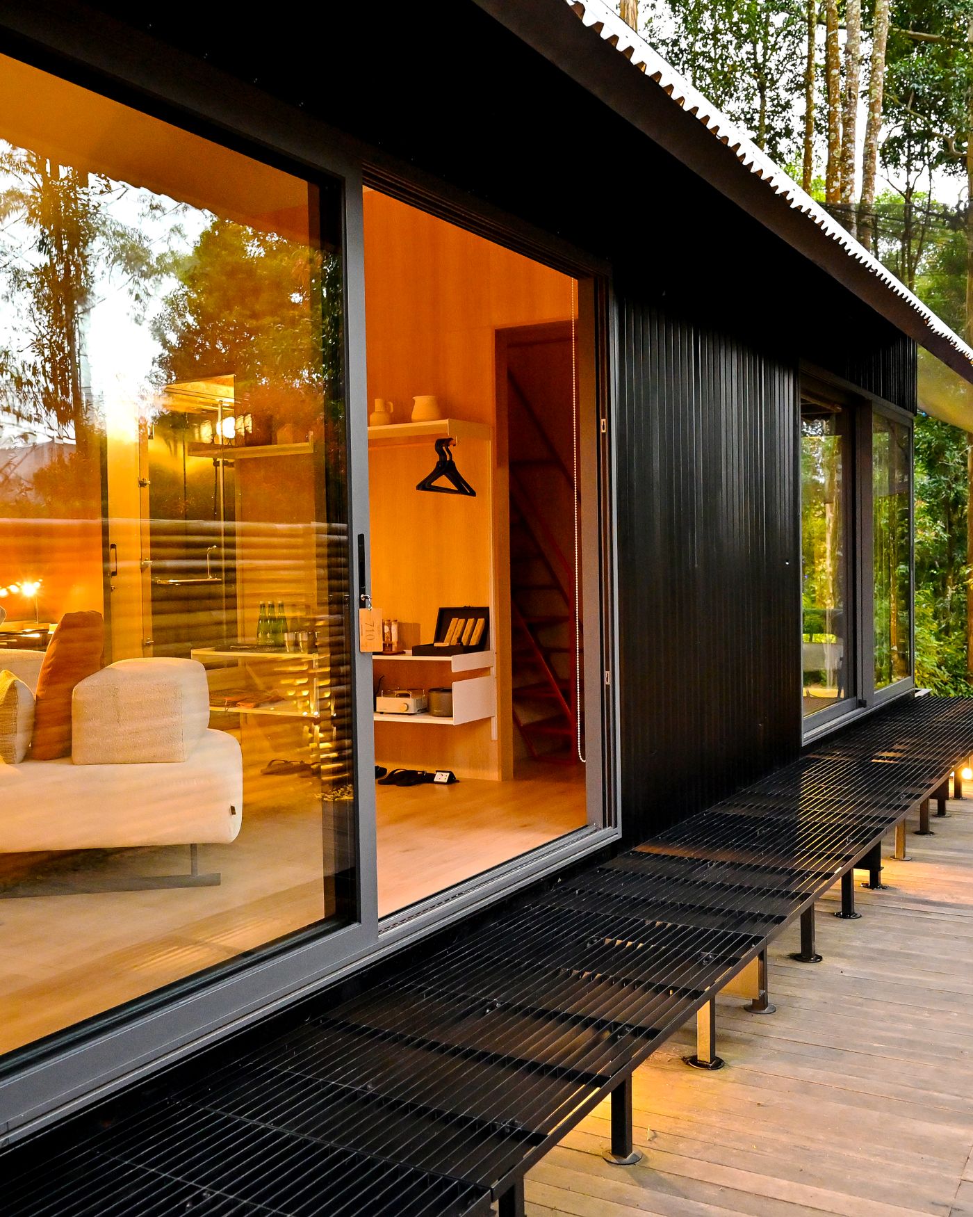 Glass-walled living room at dusk