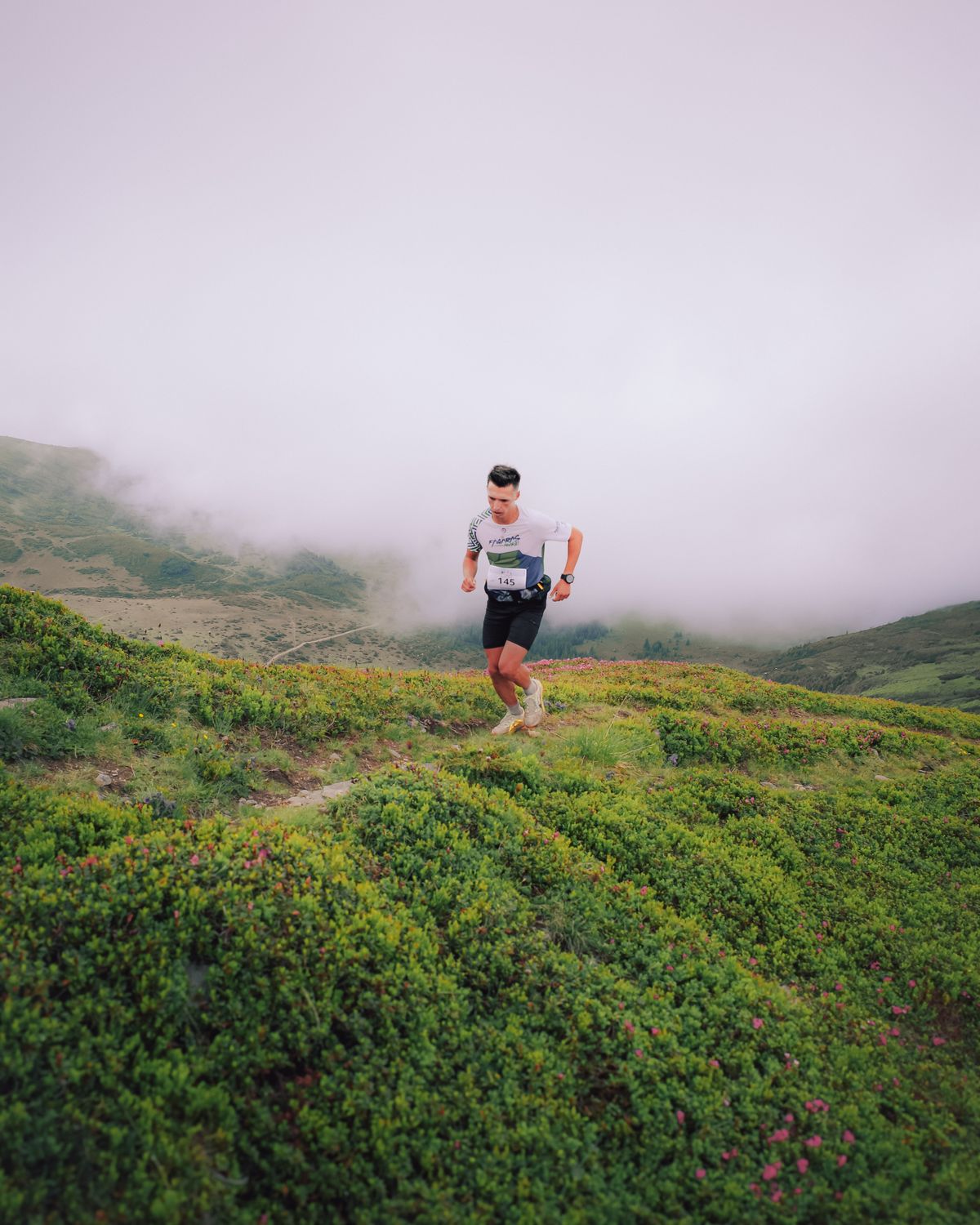 Runner in morning fog on the meadow